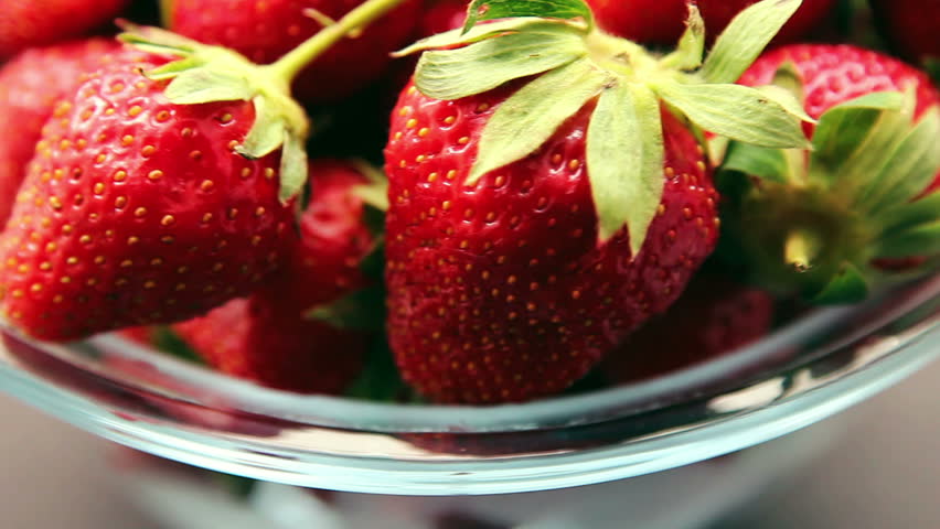 Fresh, ripe, juicy strawberries in bow rotate clockwise