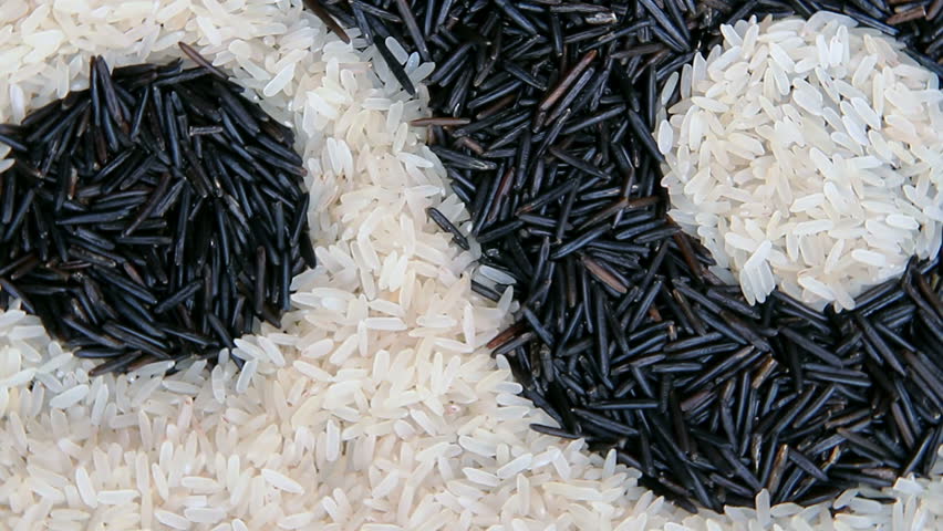 Black and white uncooked rice  forming a yin yang symbol 