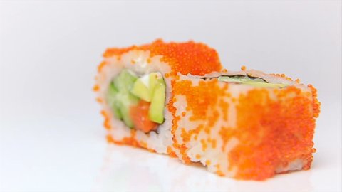 chef presentation of luxury japan restaurant sushi rolls rotating on white