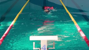 Female swimmer swims in pool HD video. Athlete speed training. Electronic clock reflected on water surface