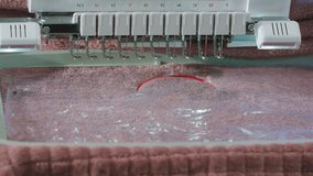 Embroidery machine starting to embroider with a needle on the fabric