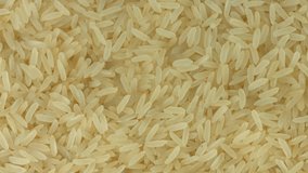 Rice background, close up raw rice rotation. Healthy food. Rotate. UHD video footage. Ultra high definition 3840X2160