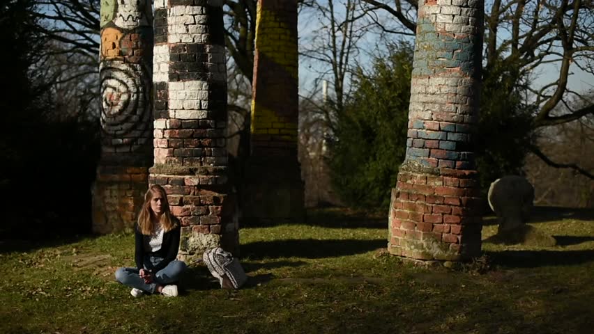 Girl sitting and enjoying beautiful spring sunny day