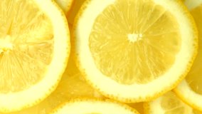 Lemon slices rotation background. Close-up of a delicious ripe lemon rotate. Healthy food, cooking ingredient. UHD video footage. Ultra high definition 3840X2160