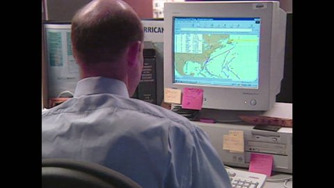UNITED STATES: 1990s: man looks at weather model on computer. Men predict hurricane route on computer. Lady looks at hurricane on chart.