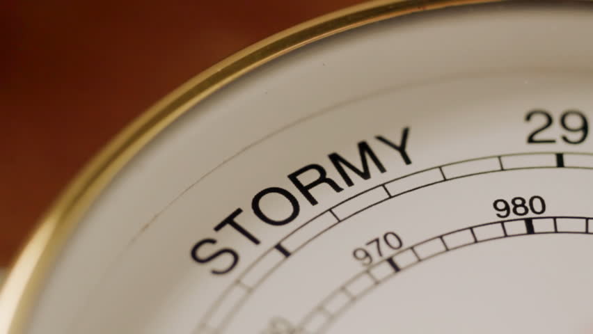 Barometer needle swings to indicate stormy weather