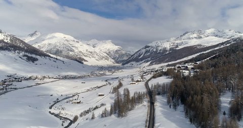 Aerial over the road leading to Livigno alps ski resort in winter, Lombardy, Italy