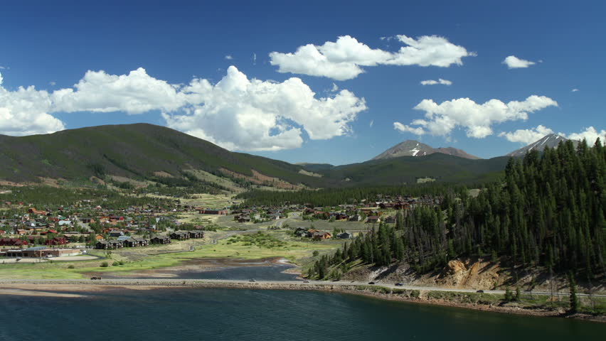 Puffy clouds in a blue sky over the mountain town of Dillon, Colorado.  HD 1080p