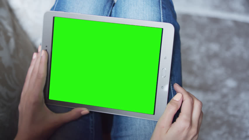 Young Woman sitting on the floor uses tablet PC with pre-keyed green screen. Few types of motion - scrolling up and down, tapping, zoom in and out. Perfect for screen compositing. 10bit ProRes 444 Royalty-Free Stock Footage #24586403