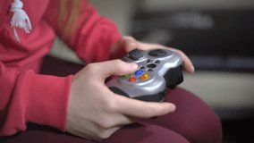 Young Woman Playing Video Game Using A Gamepad