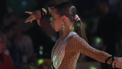 Poltava, Ukraine, Dec 2016 : Beautiful girl with artistic makeup dancing in the ballroom. Close-up, slow motion.