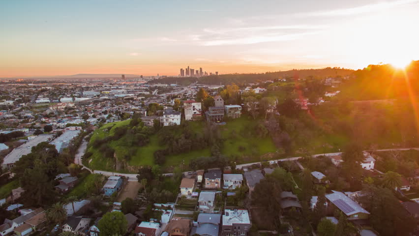 4K Aerolapse ( aerial timelapse / hyperlapse ) of the scenic city skyline view on Hollywood Hills and sunshine of the sunset in Los Angeles