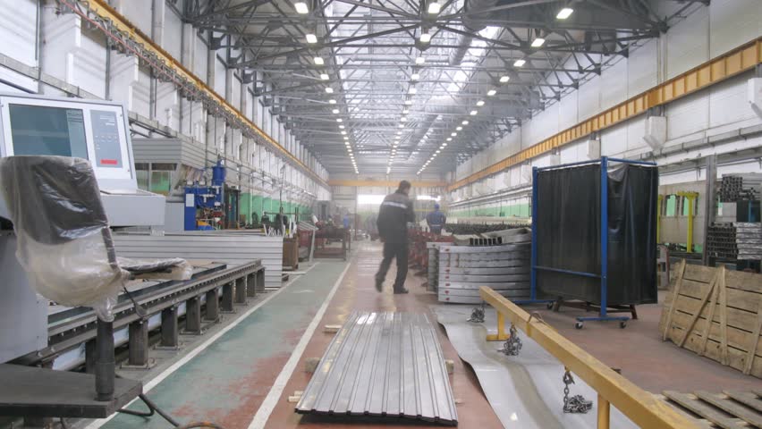 Workers go on warehouse of engineering plant, time lapse