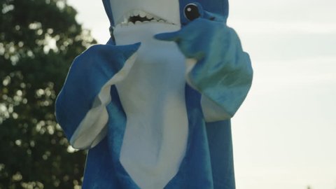 Medium Shot of Woman in Blue Shark Costume Doing Funny Dances in Slow Motion