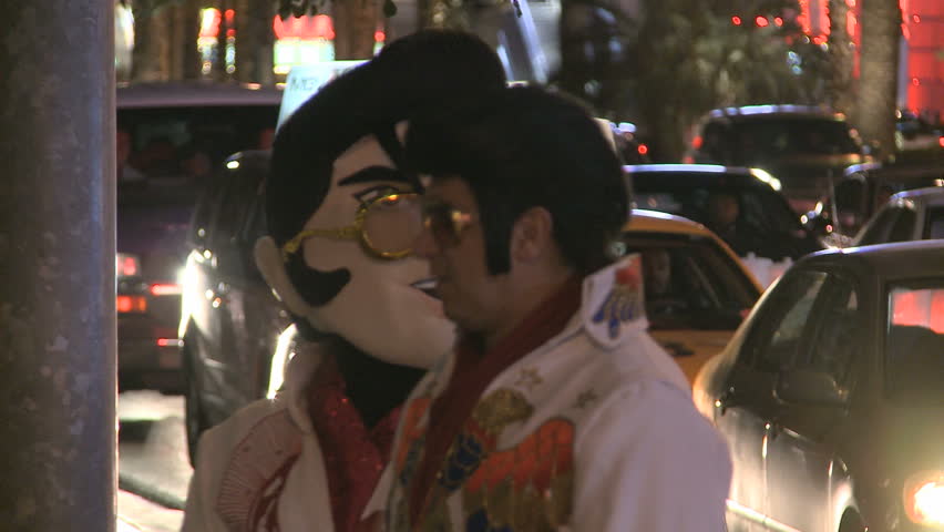 LAS VEGAS - MAR 1: An Elvis Look-alike and a person with an Elvis-mask at night