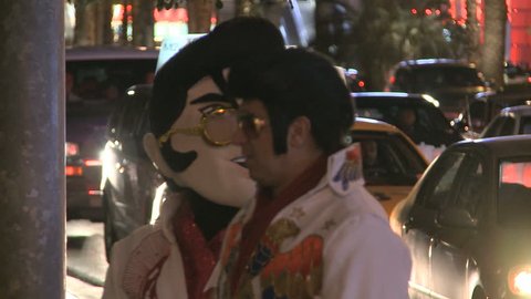 LAS VEGAS - MAR 1: An Elvis Look-alike and a person with an Elvis-mask at night on Las Vegas Boulevard on March 1, 2012 in Las Vegas, USA