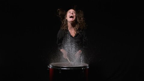 Woman playing drum and water splashing out of it. Shot with high speed camera, phantom flex 4K. Slow Motion.