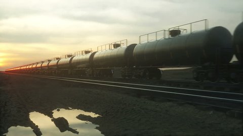 Freight train oil tankers. Against Sunrise. Realistic cinematic 4k animation.