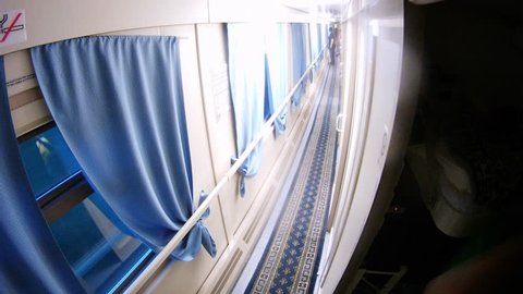 People go in corridor of compartment wagon, time lapse