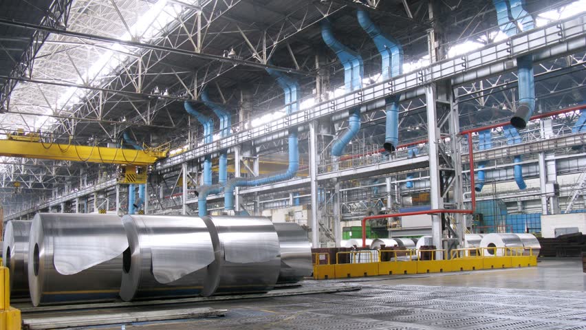 Big rolls of aluminum stand in production shop of rolling mill, time lapse