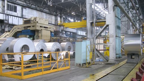  (Timelapse View) Roll of aluminum moves on special rails in production shop of rolling mill