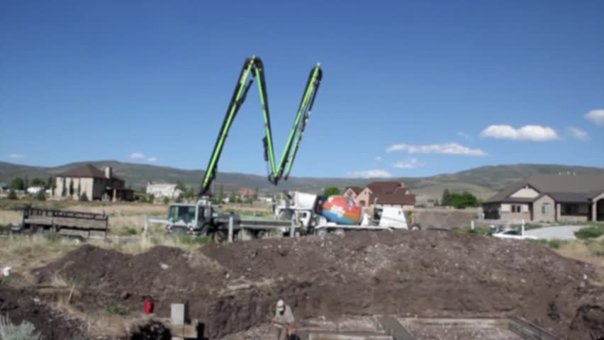 A cement pump truck pouring the footings of a house