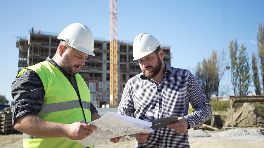 Architect talkng with contruction manager. Royalty-Free Stock Footage #24625550