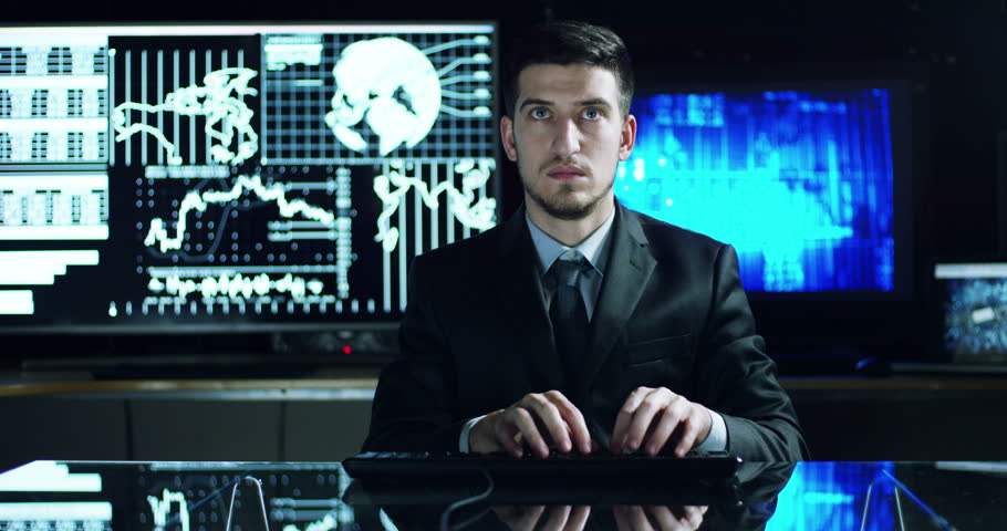 A young man controls the financial purse and the economy graphs to check the financial workflows and watch the monitors and writes to see 'stock quotes in his office | Shutterstock HD Video #24629906