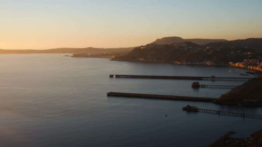 Panning shot of sunset over the seaside with flare effect. Naples bay and the island of Nisida - HD