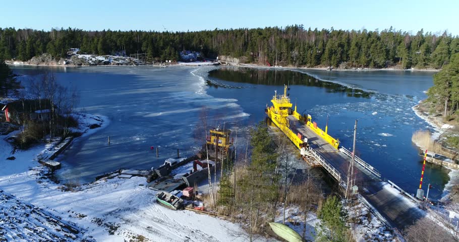 Cinema 4k aerial on the side of a cable ferry, docked at Orslandet, in Barosund or Baronsalmi of the finnish archipelago, of Inkoo, Finland.