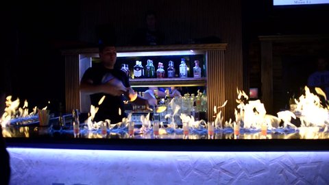 KHERSON, UKRAINE - MARCH 04, 2017: Bartender show performance with fire juggling and alcohol