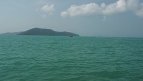 Make a vdo clip during the riding taking a speed boat around the sea with The view of some island in Thailand 