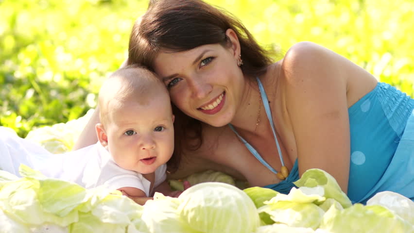 Mother and newborn baby lying in the cabbage
