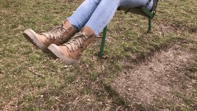 Outdoor scene of woman swinging on chain seat slow motion 1920X1080 HD video - Modern clothed female relaxing in the park slow-mo 1080p FullHD footage