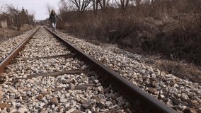 Daily scene with woman walking on rails 4K 2160p 30ffps UltraHD footage - Female on abandoned railroad 3840X2160 UHD video