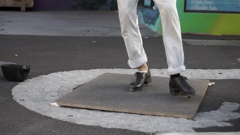 Busker artist dancing tip tap on the street