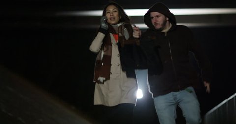4k, Young Asian woman talking on her mobile phone gets her purse snatched by a man in a hoodie.