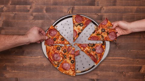 Top view of baking a pizza with hands taking slices and empty the plate - stop motion animation