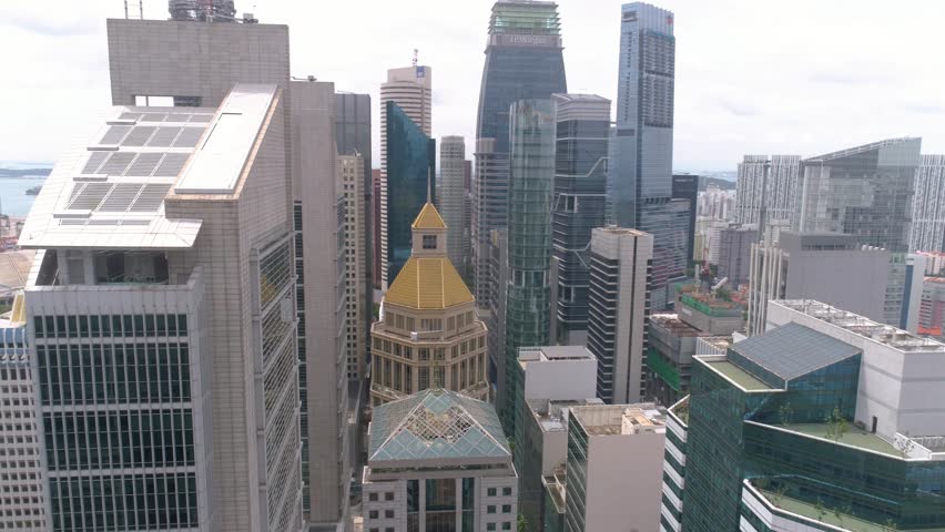 A cluster of skyscrapers stands near the Singapore River in Singapore.