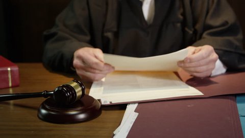Judge closes up folder and hammers his gavel to end court case