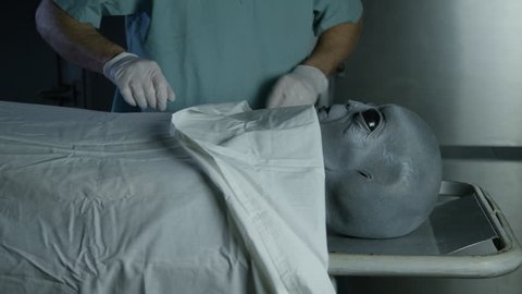 Alien Autopsy - covering visitor head on gurney with sheet