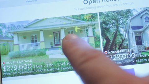 TAMPA, FL - MARCH 8: Using Zillow mobile website application on tablet computer on March 8, 2017. Zillow Group is an online real estate database company of homes for sale and rental property.