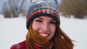 Beauty young woman with red long hair enjoying winter day outside