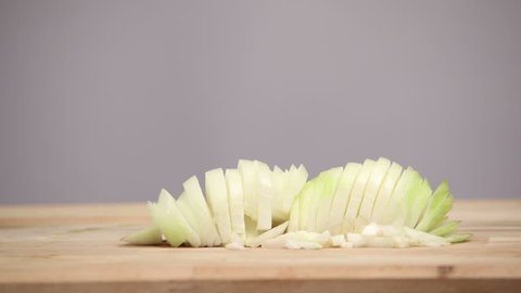 Cutting vegetables on wooden cutting board. Food stop motion animation.