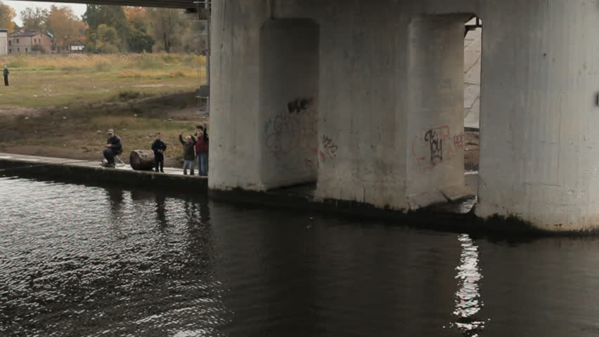 Children playing under the bridge. Riga, Bolderaja, Latvia.