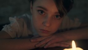 Sad little girl with a candle - Powered by Shutterstock - Get 15% off with code: PIKWIZARD15