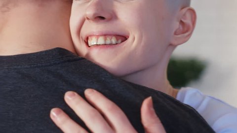 Happy and smiling cancer patient woman hugging her supporting husband