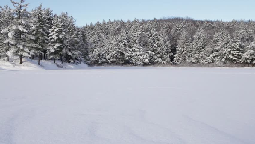 Pan to Footprints on Desolate Frozen Lake
