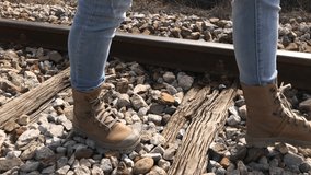 Slow motion of woman steps on railroad ties and stone 1080p FullHD footage - Female walks on old train rails slow-mo 1920X1080 HD video