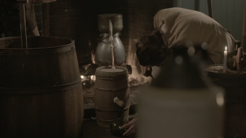 VIRGINIA - SUMMER 2016 - Reenactment, Recreation, old Tavern, saloon, bar before fireplace - 18th / 19th man works century alcohol distillery, still - copper pipes, mash and rum bottles. Gin, whiskey 